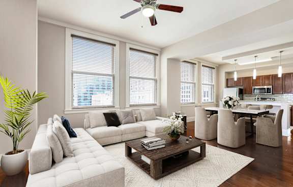 A living room with a white couch and a brown coffee table.