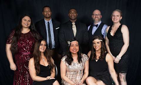 a group of people posing for a photo at a party
