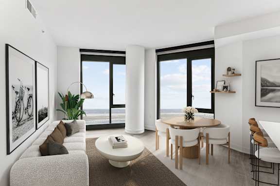 A modern living room with a large window overlooking the ocean.