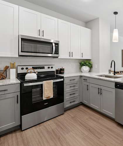 A modern kitchen with a black oven and stove top.