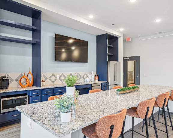 a kitchen with a large island and a table with chairs