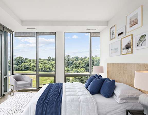 a bedroom with a bed and a view of a large window