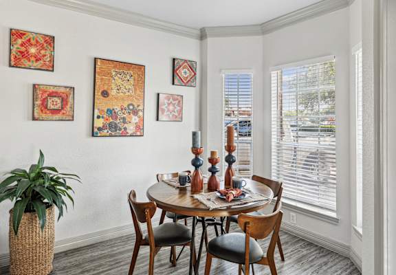 A dining room with a round table and chairs.