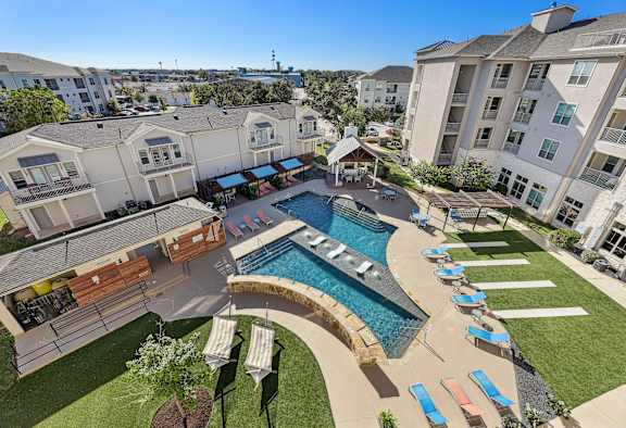 an aerial view of an apartment complex with a swimming pool