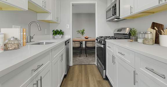 a kitchen with white cabinets and stainless steel appliances at Courthouse Square Apartments, Towson, 21286