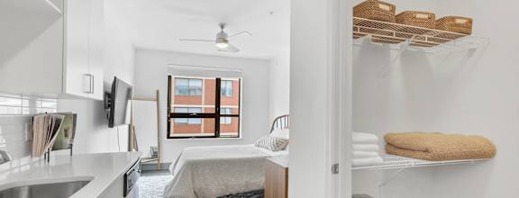 a kitchen with a sink and a bedroom with a bed