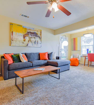 a living room with a couch coffee table and fireplace  at Riverset Apartments, Memphis
