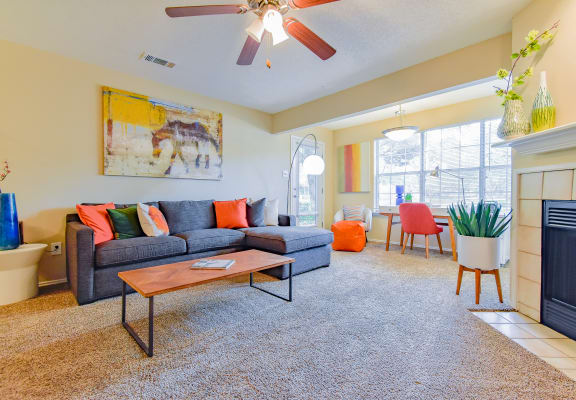 a living room with a couch coffee table and fireplace  at Riverset Apartments, Memphis