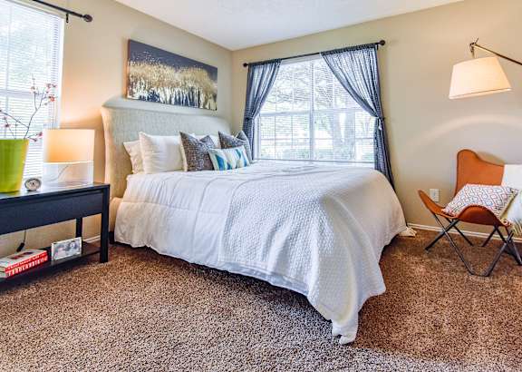 a bedroom with a large bed and a bathroom at Riverset Apartments, Memphis, 38103