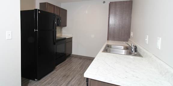 a kitchen with wooden cabinets and white appliances