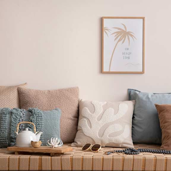a couch with pillows and a tray with various pillows on it at BASE APARTMENT HOMES, LAS VEGAS, NV