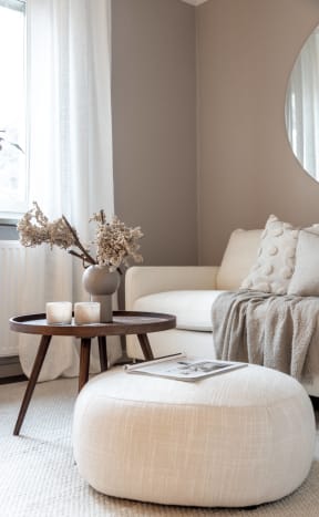 a living room with a white couch and a table with a vase on it at The Groves, North Carolina