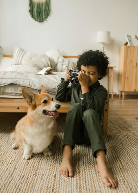 a child tacking a picture of a dog at Pinewood Townhomes in Tucker, GA 30084