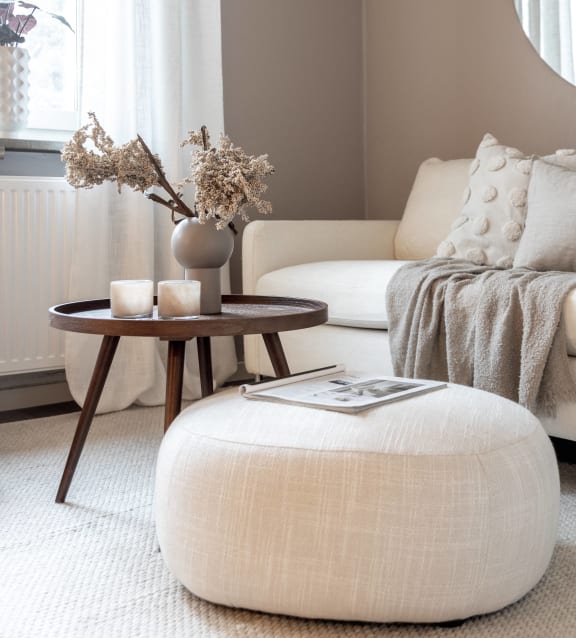 a living room with a white couch and a table with a vase on it at Willow Bend Apartments, North Carolina, 27707