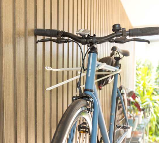 A blue bicycle is hanging on a wall at Nook at Northaven Apartments, Washington, 98125