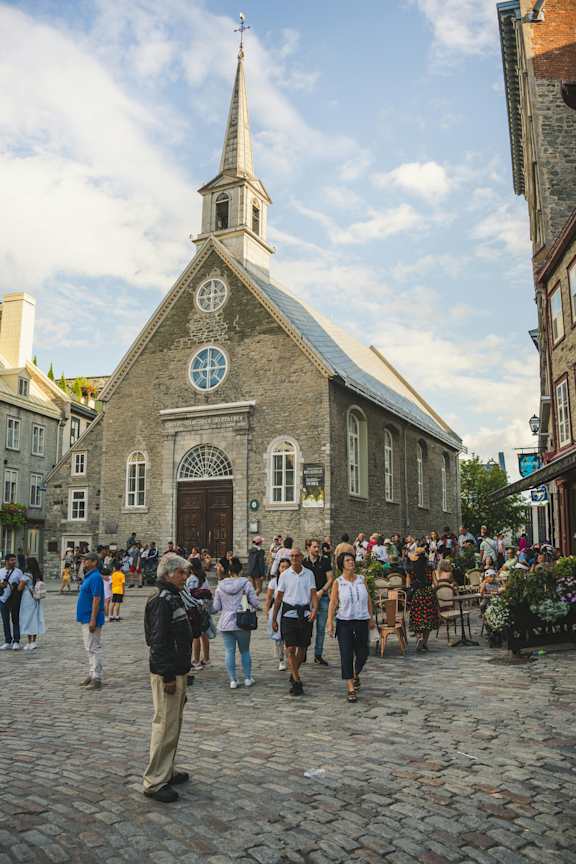 a crowd of people walking in front of a church