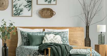 A bedroom with a bed, pillows, blankets, and decorative items.