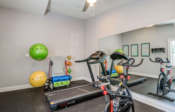 plenty of exercise equipment at the whispering winds apartments in pearland, tx