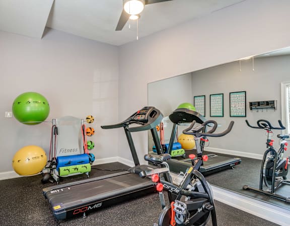 plenty of exercise equipment at the whispering winds apartments in pearland, tx