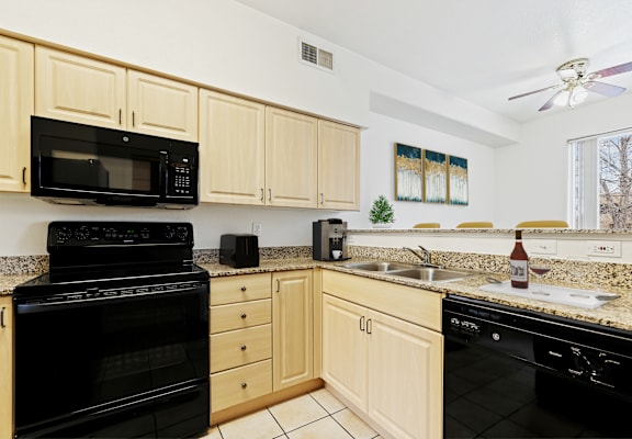 the kitchen is equipped with a dishwasher and a stove top oven