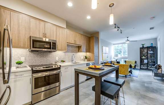 A modern kitchen with a dining table and chairs.