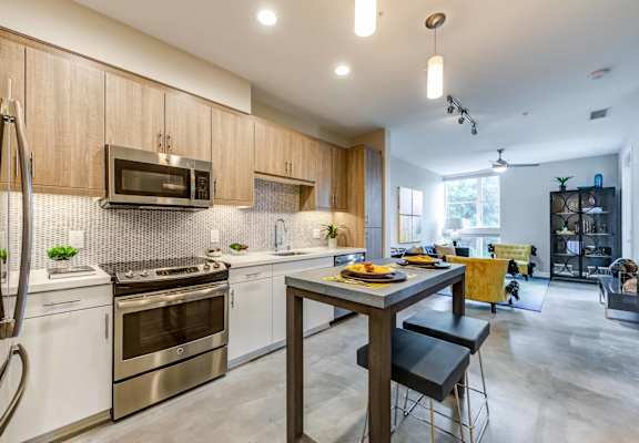 A modern kitchen with a dining table and chairs.