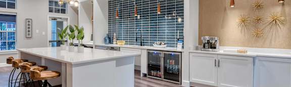 an open kitchen with white cabinets and a white counter top