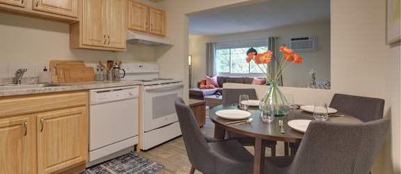 A kitchen with a table and chairs set for two.