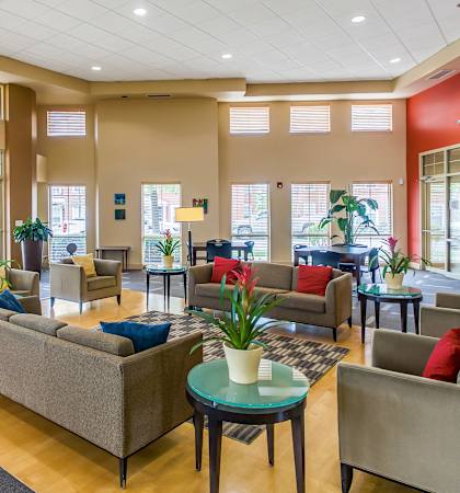 a large lobby with couches and chairs and tables