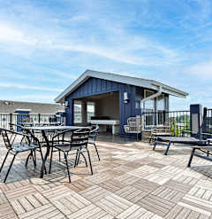 A patio with a table and chairs is set up on a rooftop.