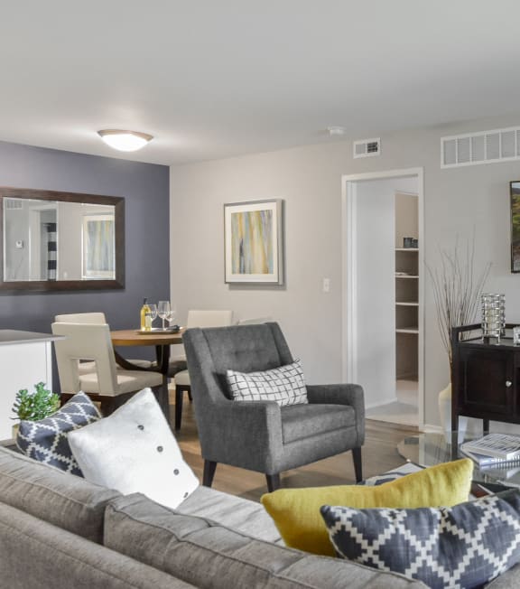 a living room with a couch and chairs and a tv