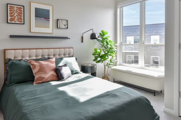 a bedroom with a large bed and a window
