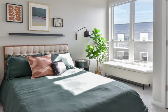 a bedroom with a large bed and a window