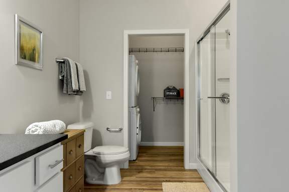 a bathroom with a shower and a toilet and a sink