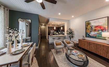 A modern dining room with a wooden table and chairs.
