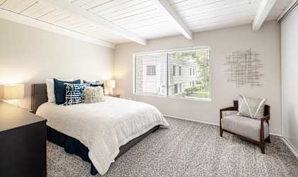a bedroom with a bed and a chair
