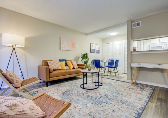 The Pearl at Highland Village Apartments and Townhomes for rent in Jackson, MS photo of a living room with a couch and a chair and a table