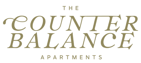 The image shows a logo for "The Counter Balance Apartments" with stylized text.