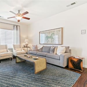 a living room with a couch and a ceiling fan