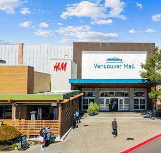 the front of a mall with people walking into the building at AVIA Lofts on Parkway Apartments, Vancouver, 98662