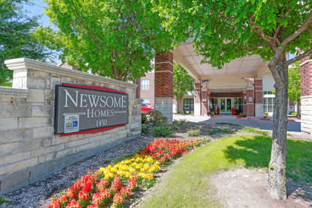 The entrance to Newsome Homes is framed by a beautiful flower bed.