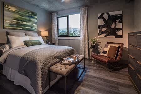 a bedroom with a bed and a chair