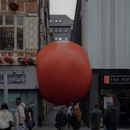 a big red balloon in the street