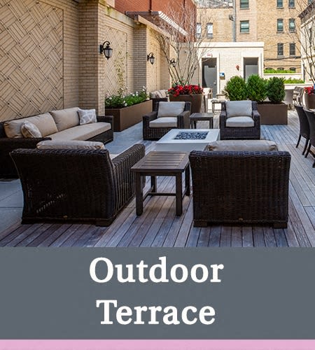 an outdoor terrace with rattan furniture and a table