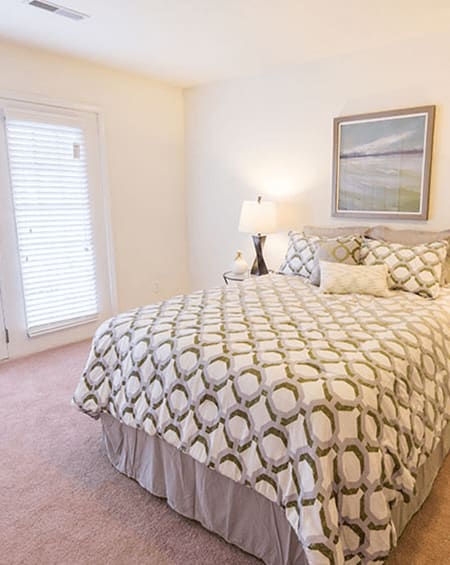 a bedroom with a large bed and a window