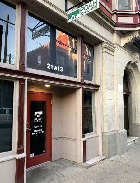 a building on the corner of a street with cars parked in front of it