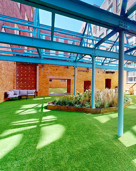A green lawn with a blue metal structure above it.