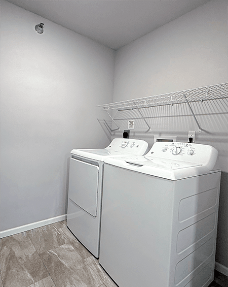 A white double sink vanity in a small bathroom.