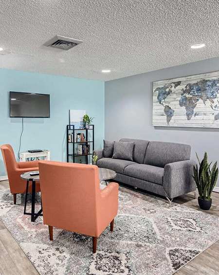 a living room with a couch and a table and chairs
