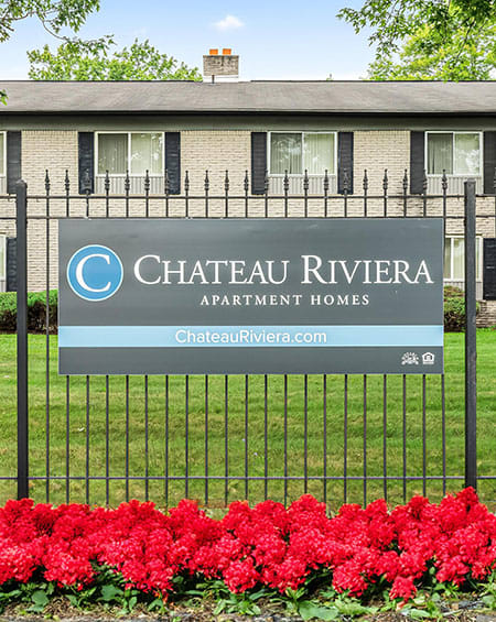 a sign on a fence in front of a building
